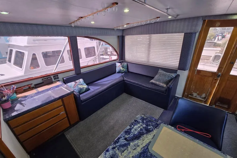  Yacht Photos Pics Interior of 1988 Topaz 44 Flybridge yacht with blue seating and wooden accents.