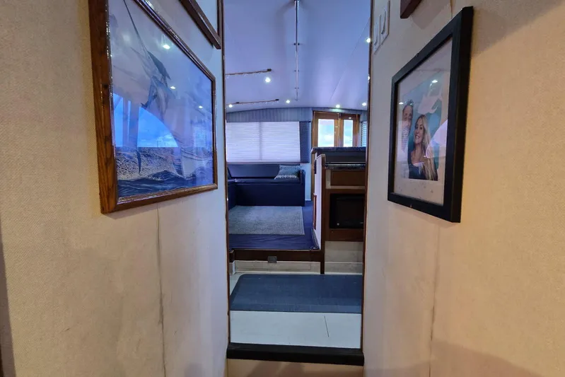  Yacht Photos Pics Interior hallway of 1988 Topaz 44 Flybridge yacht with framed photos on walls.