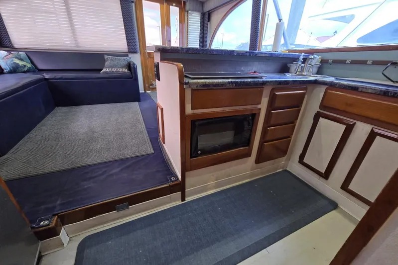  Yacht Photos Pics Interior of 1988 Topaz 44 Flybridge yacht with kitchen and seating area.