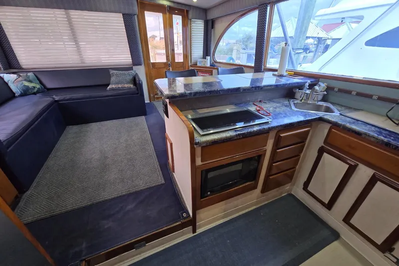  Yacht Photos Pics Interior of 1988 Topaz 44 Flybridge yacht with kitchen and seating area.