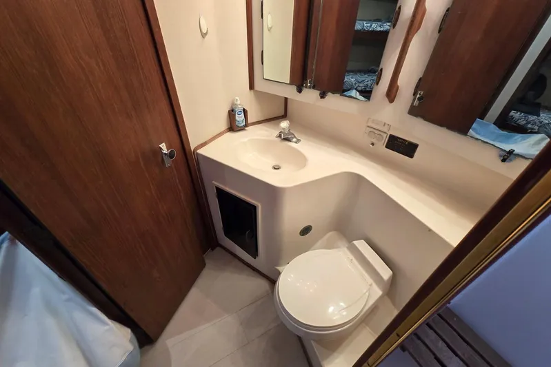  Yacht Photos Pics Bathroom interior of 1988 Topaz 44 Flybridge yacht with sink, toilet, and mirror.