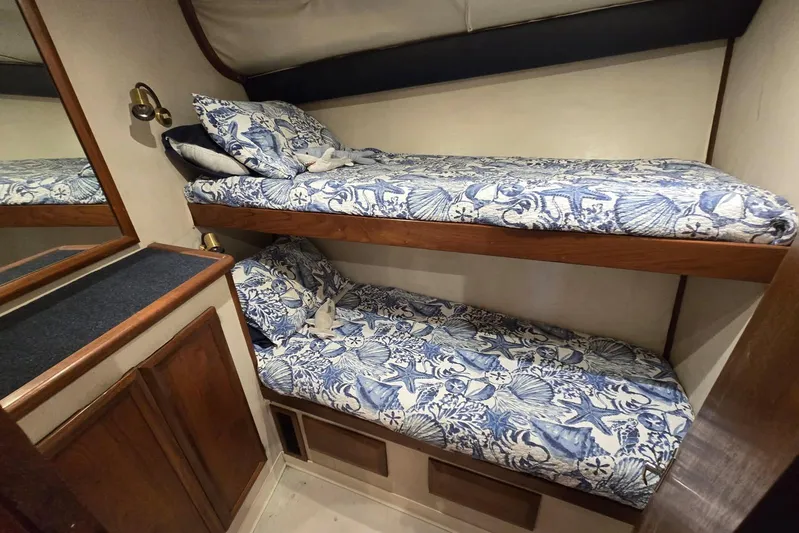  Yacht Photos Pics Bunk beds with nautical-themed bedding in a 1988 Topaz 44 Flybridge cabin.