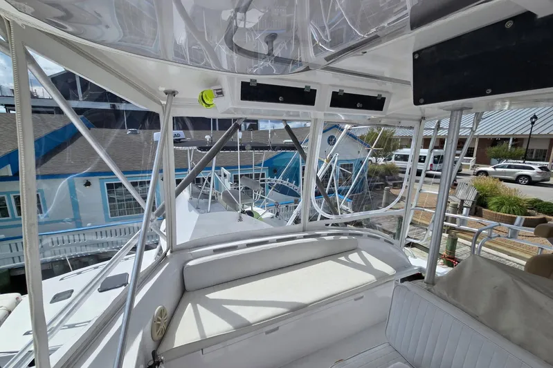  Yacht Photos Pics 1988 Topaz 44 Flybridge interior view with seating and marina backdrop.