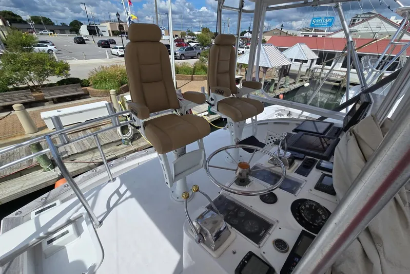  Yacht Photos Pics 1988 Topaz 44 Flybridge boat helm with dual captain chairs and control panel.