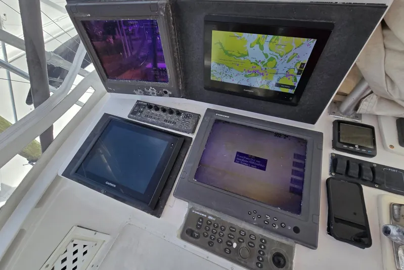  Yacht Photos Pics Control panel of a 1988 Topaz 44 Flybridge with navigation screens and instruments.