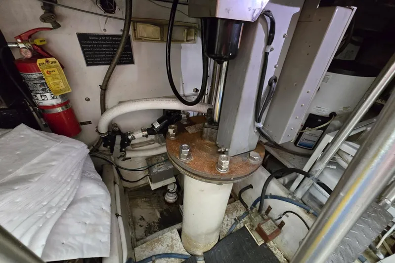  Yacht Photos Pics Engine room of 1988 Topaz 44 Flybridge with hydraulic components and fire extinguisher.
