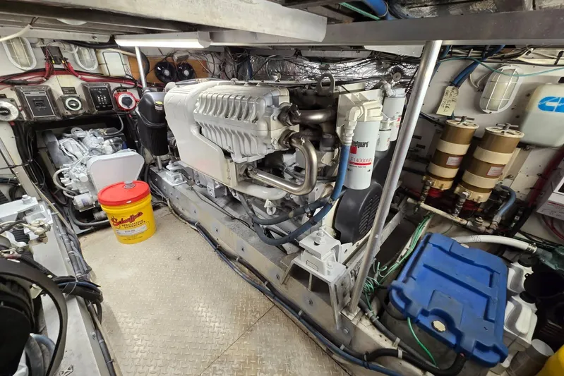  Yacht Photos Pics Engine room of a 1988 Topaz 44 Flybridge boat, showcasing machinery and equipment.