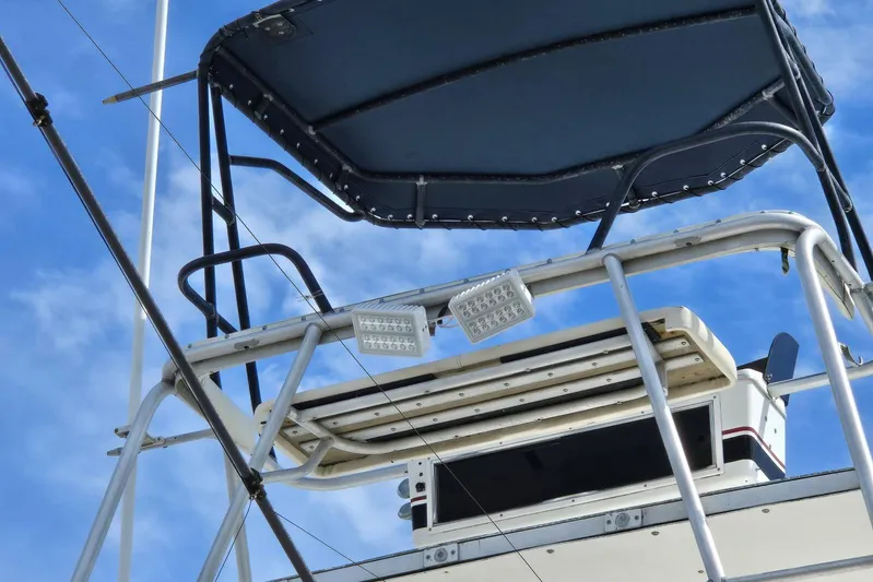  Yacht Photos Pics Flybridge of 1988 Topaz 44 boat with canopy and lights against blue sky.