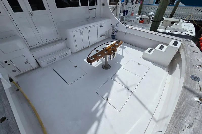  Yacht Photos Pics 1988 Topaz 44 Flybridge boat deck with fishing rod holders and storage compartments.