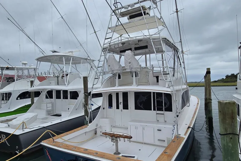  Yacht Photos Pics 1988 Topaz 44 Flybridge yacht docked, featuring spacious deck and fishing equipment.