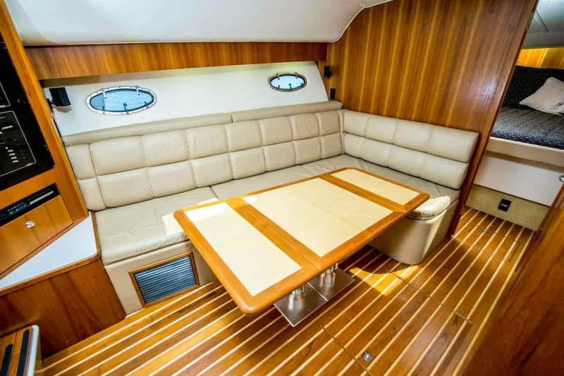 Bluefin Yacht Photos Pics Luxurious interior of 2000 Tiara 41 Open yacht with leather seating and wooden accents.