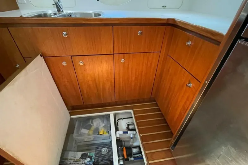 Bluefin Yacht Photos Pics 2000 Tiara 41 Open yacht kitchen with wooden cabinets and storage compartment.