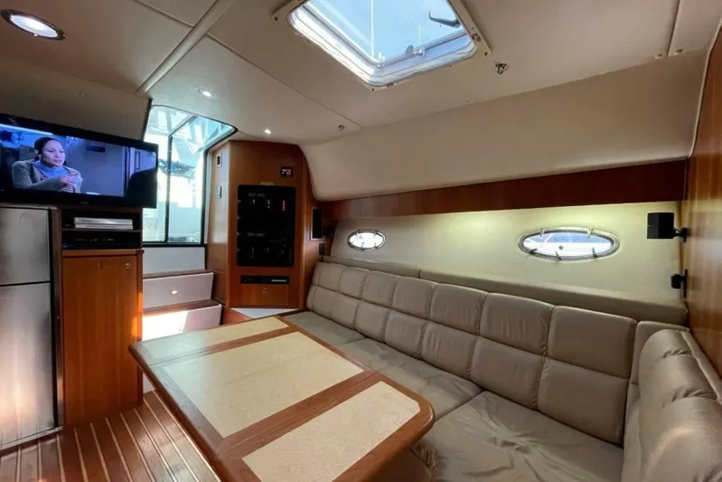 Bluefin Yacht Photos Pics Luxurious interior of 2000 Tiara 41 Open yacht with cozy seating and entertainment system.