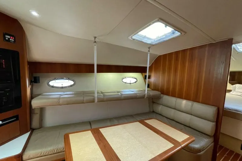 Bluefin Yacht Photos Pics Interior of 2000 Tiara 41 Open yacht with cozy seating and wooden accents.