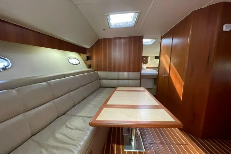 Bluefin Yacht Photos Pics Luxurious interior of a 2000 Tiara 41 Open yacht with leather seating and wooden finishes.