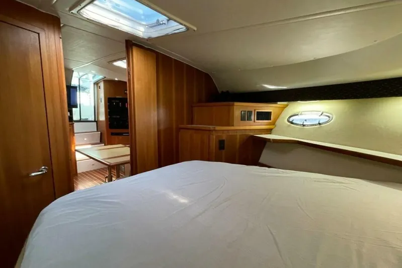 Bluefin Yacht Photos Pics Interior of 2000 Tiara 41 Open yacht, featuring cozy cabin and wooden finishes.