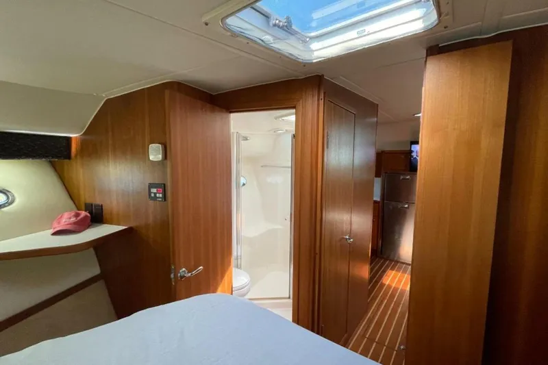 Bluefin Yacht Photos Pics Interior of 2000 Tiara 41 Open yacht with wood paneling and skylight.