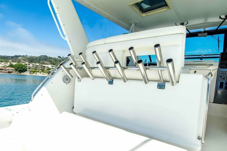 Bluefin Yacht Photos Pics Tiara 41 Open 2000 yacht interior with rod holders, overlooking serene waterfront.