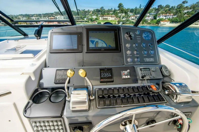 Bluefin Yacht Photos Pics Cockpit of 2000 Tiara 41 Open yacht with navigation instruments and steering wheel.
