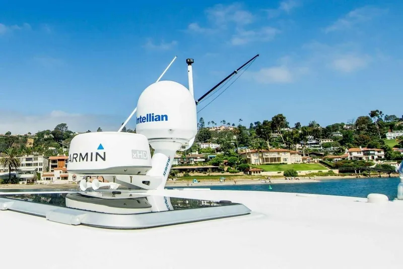 Bluefin Yacht Photos Pics Tiara 41 Open 2000 yacht with Garmin and Intellian equipment, coastal background.