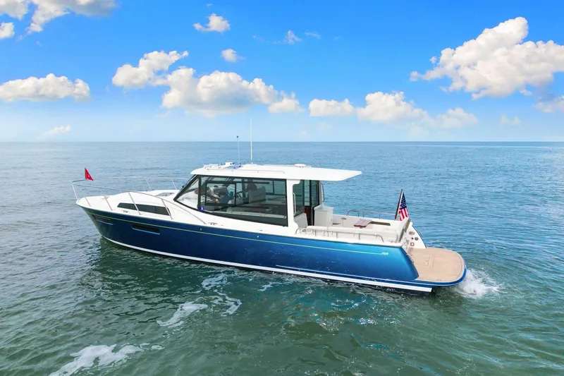 Mjm 42 For Sale Yacht Photos Pics 2024 MJM 42 yacht cruising on open water under a clear blue sky.