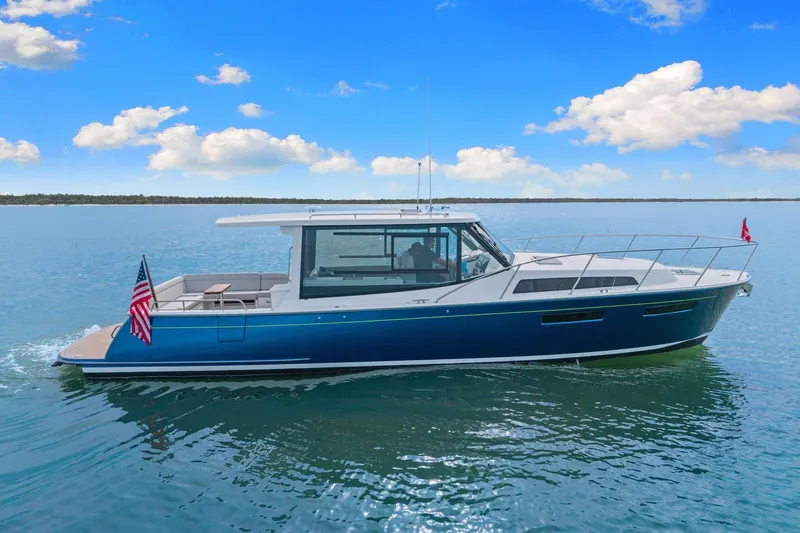 Mjm 42 For Sale Yacht Photos Pics 2024 MJM 42 yacht cruising on calm waters under a clear blue sky.