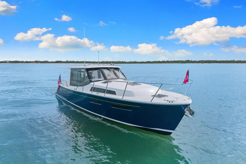 Mjm 42 For Sale Yacht Photos Pics 2024 MJM 42 yacht cruising on calm blue waters under a clear sky.