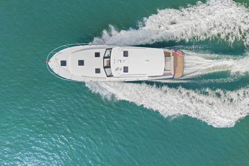 Mjm 42 For Sale Yacht Photos Pics Aerial view of 2024 MJM 42 yacht cruising on turquoise water.