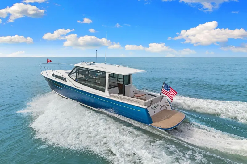 Mjm 42 For Sale Yacht Photos Pics 2024 MJM 42 yacht cruising on open water under a clear blue sky.