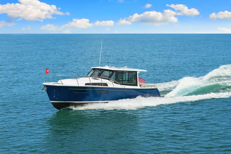 Mjm 42 For Sale Yacht Photos Pics 2024 MJM 42 yacht cruising on open sea under clear blue sky.