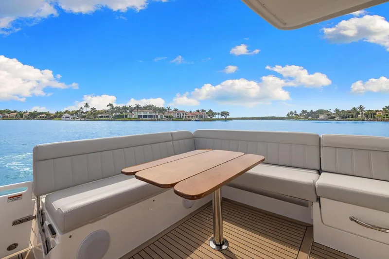 Mjm 42 For Sale Yacht Photos Pics 2024 MJM 42 yacht deck with seating and table, overlooking serene waterfront view.