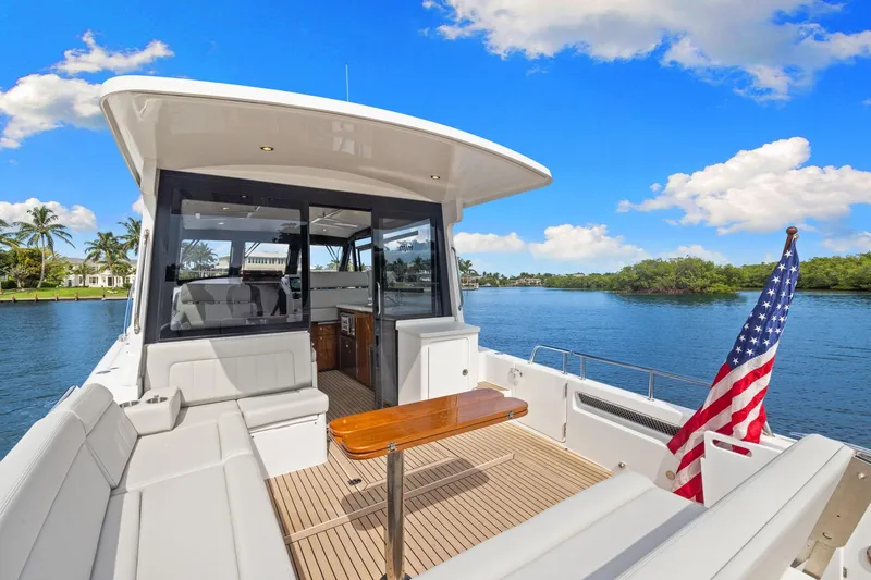 Mjm 42 For Sale Yacht Photos Pics 2024 MJM 42 yacht interior with American flag, docked on a sunny day.