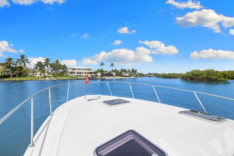 Mjm 42 For Sale Yacht Photos Pics 2024 MJM 42 yacht cruising on a sunny day with palm trees and blue sky.