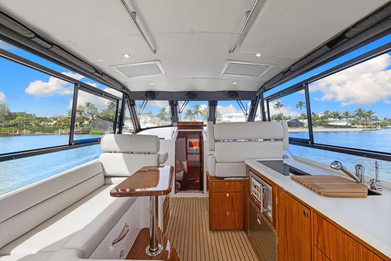 Mjm 42 For Sale Yacht Photos Pics Luxurious interior of 2024 MJM 42 yacht with modern seating and kitchen area.
