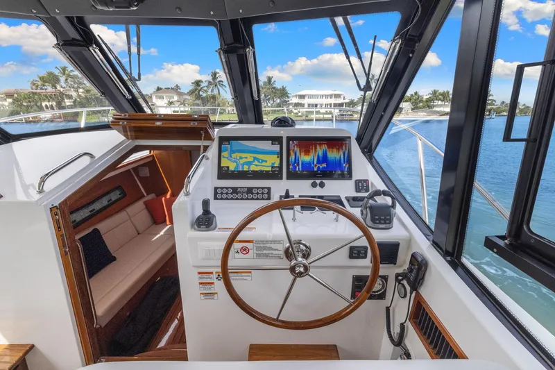 Mjm 42 For Sale Yacht Photos Pics 2024 MJM 42 yacht helm with navigation screens, steering wheel, and luxurious interior view.