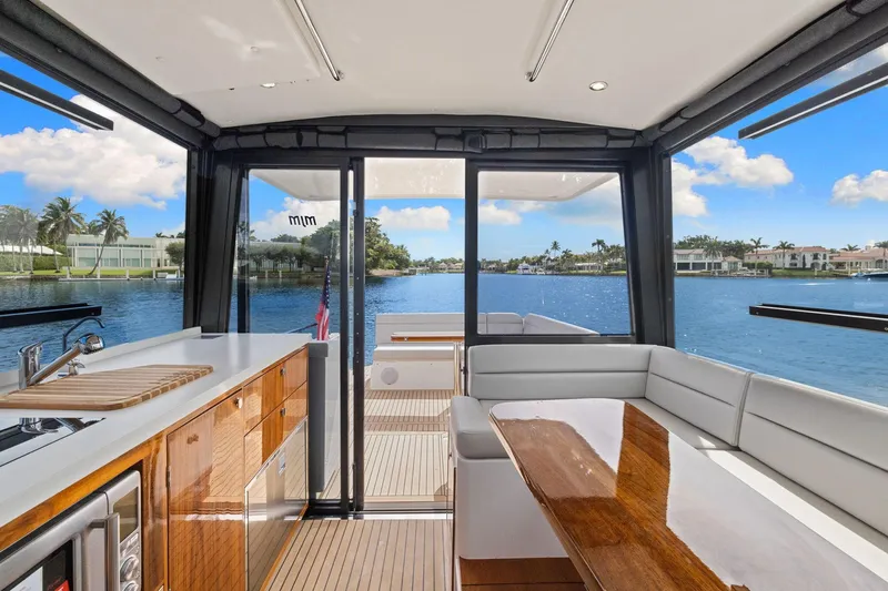 Mjm 42 For Sale Yacht Photos Pics Interior view of 2024 MJM 42 yacht with elegant seating and waterfront backdrop.