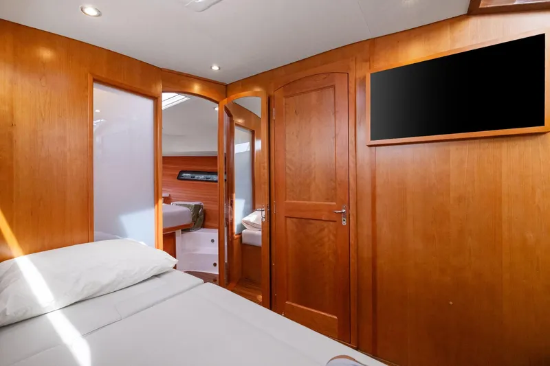 Mjm 42 For Sale Yacht Photos Pics Luxurious interior of 2024 MJM 42 yacht with wooden finishes and cozy bedding.