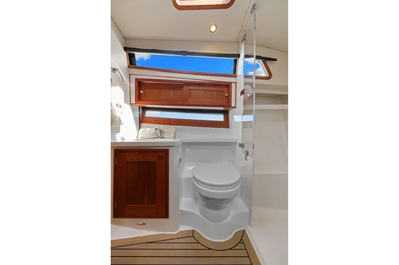 Mjm 42 For Sale Yacht Photos Pics Luxurious bathroom in 2024 MJM 42 yacht with wooden cabinetry and modern fixtures.