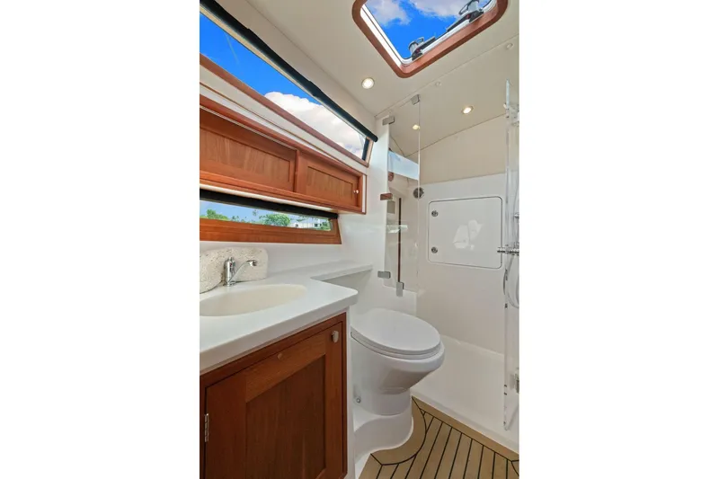 Mjm 42 For Sale Yacht Photos Pics Luxurious bathroom in 2024 MJM 42 yacht with skylight and modern fixtures.
