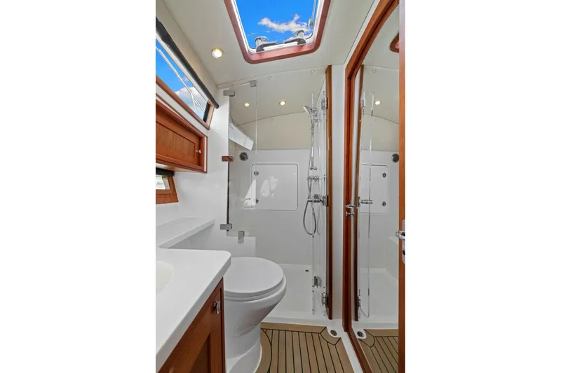 Mjm 42 For Sale Yacht Photos Pics Luxurious bathroom in 2024 MJM 42 yacht with skylight and modern fixtures.