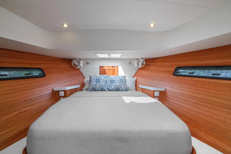 Mjm 42 For Sale Yacht Photos Pics Luxurious cabin interior of 2024 MJM 42 yacht with wood paneling and cozy bedding.