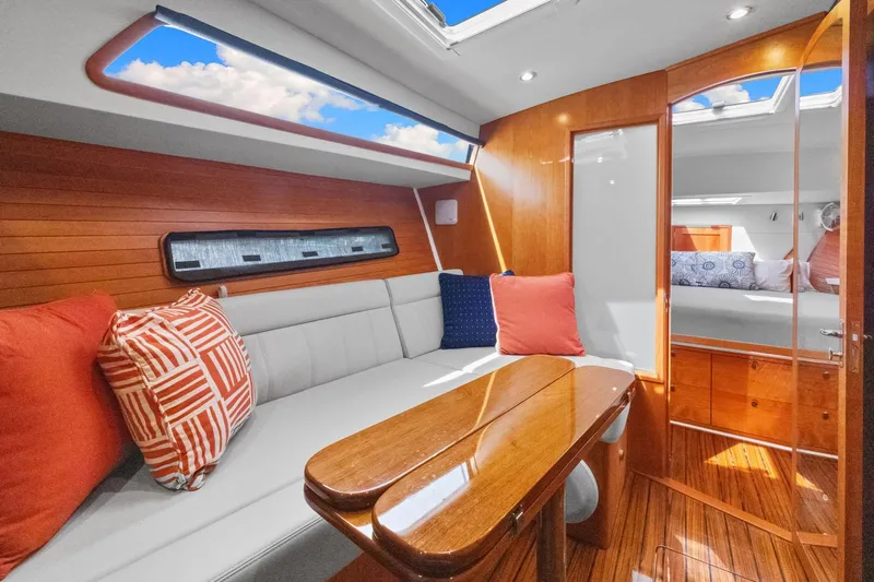 Mjm 42 For Sale Yacht Photos Pics Luxurious interior of 2024 MJM 42 yacht with elegant wood finishes and plush seating.