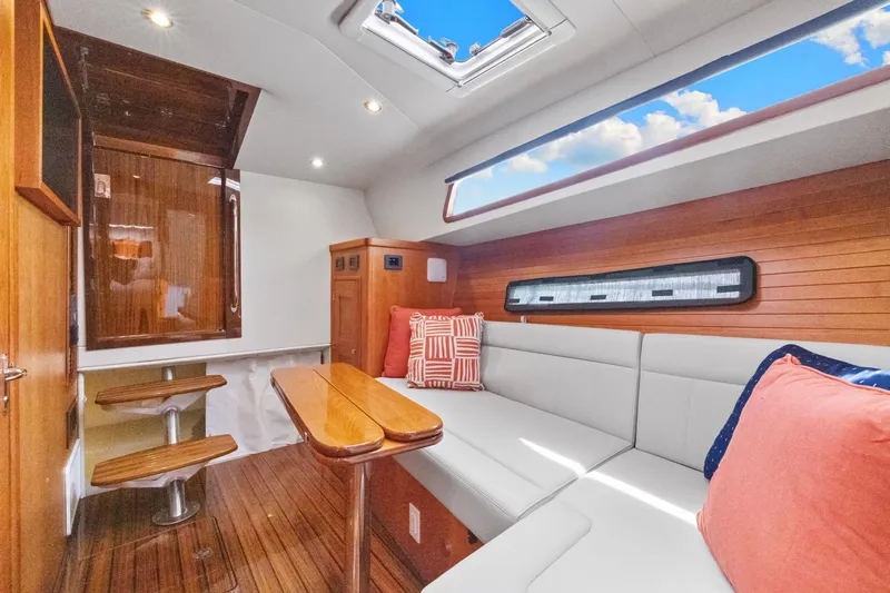 Mjm 42 For Sale Yacht Photos Pics Luxurious interior of 2024 MJM 42 yacht with wooden accents and plush seating.