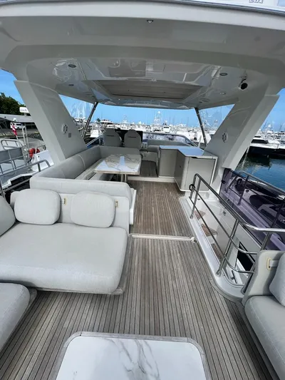 Yacht Photos Pics 2019 Azimut 60 Flybridge yacht with spacious seating and dining area.