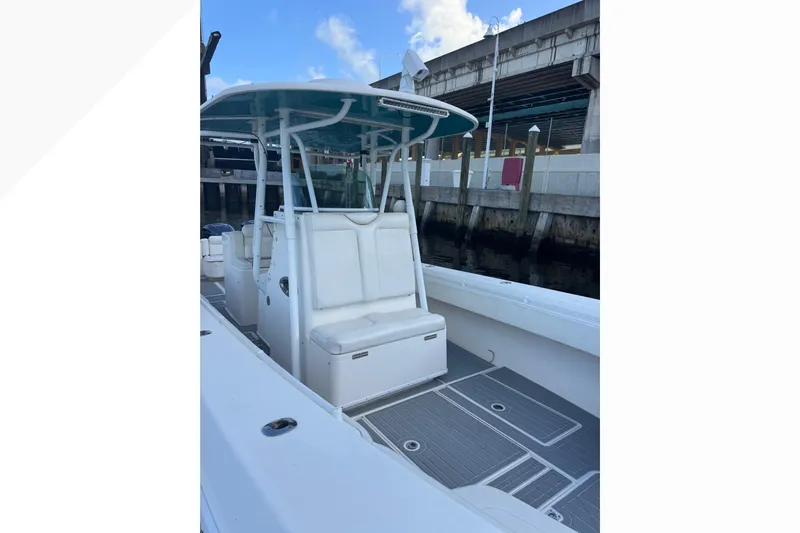  Yacht Photos Pics 2012 Contender 35 LS boat with seating and T-top at a dock.