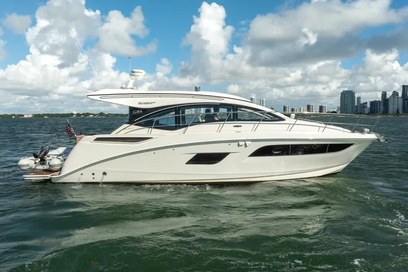  Yacht Photos Pics 2016 Sea Ray 400 Sundancer yacht cruising on open water under a cloudy sky.