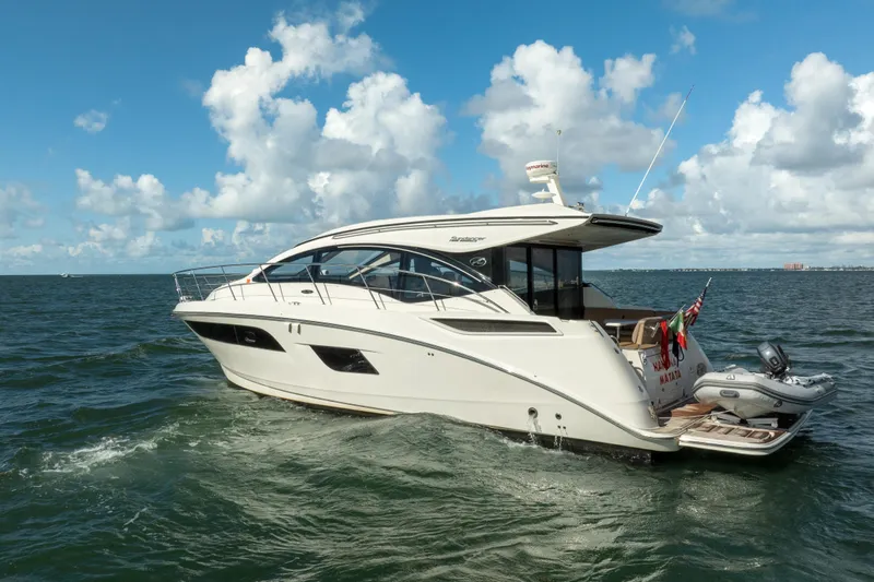 Yacht Photos Pics 2016 Sea Ray 400 Sundancer yacht cruising on open water under a blue sky.