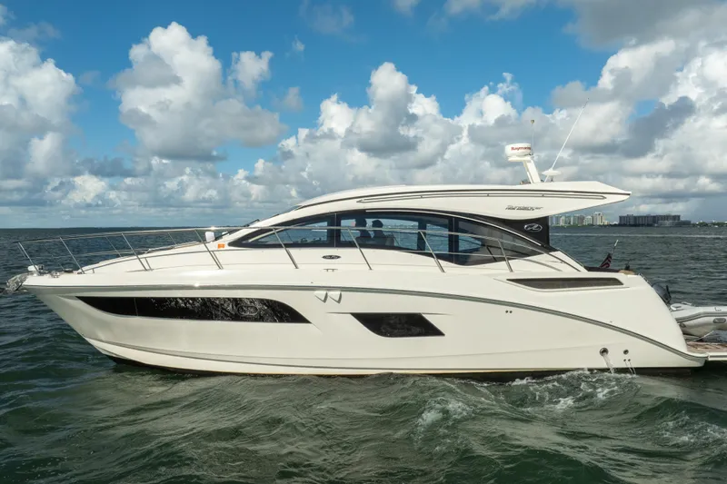  Yacht Photos Pics 2016 Sea Ray 400 Sundancer yacht cruising on open water under a partly cloudy sky.