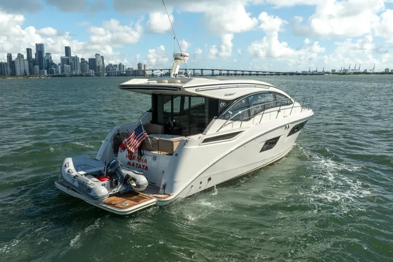  Yacht Photos Pics 2016 Sea Ray 400 Sundancer yacht cruising near city skyline on a sunny day.