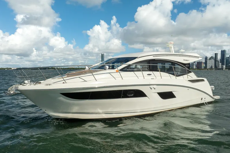  Yacht Photos Pics 2016 Sea Ray 400 Sundancer yacht on water with city skyline background.